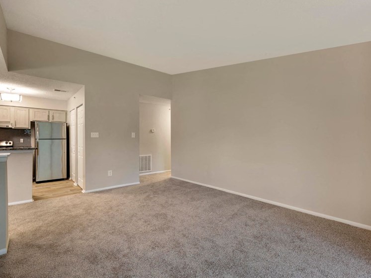 Carpeted Open Floor with Kitchen with Stainless Steel Appliances